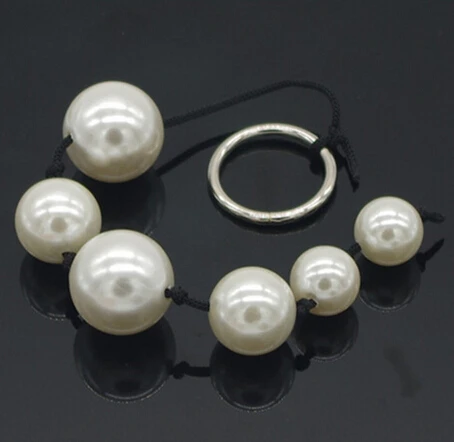 Female using anal beeds Female using anal beeds