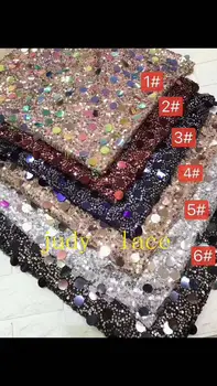 

6-colour round sequins embroidered sequin fabric of African style are used in the wedding dress fashion stage