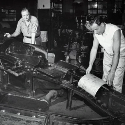 Two male workers working in a printing press Poster Print (24 x 36)