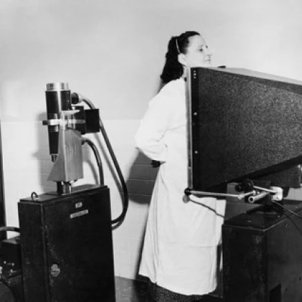 Male radiologist taking an x-ray of a female patient Poster Print (24 x 36)