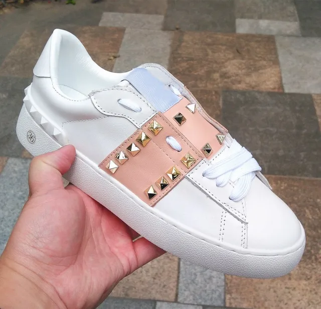 white sneakers with gold studs