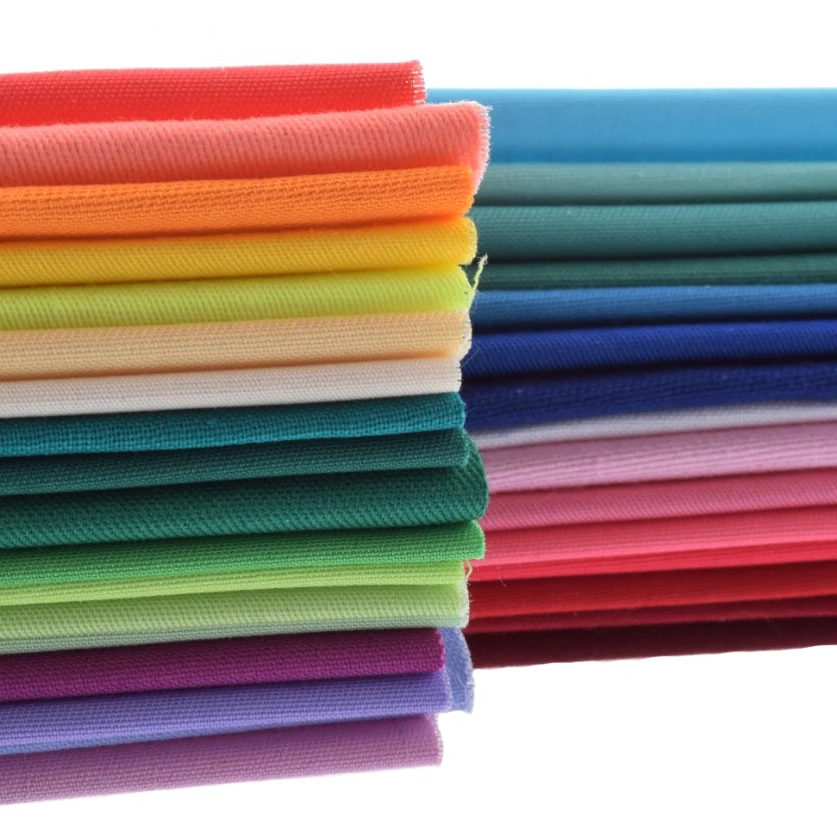 материалы для рукоделия. ткань для шитья и рукоделия. швейная фурнитура. стопка тканей. ткань для шитья одежды.