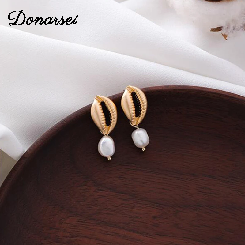 

Donarsei Sweet Simulated Pearl Sea Shell Dangle Earrings For Women Cute Irregular Gold Metal Conch Drop Earrings