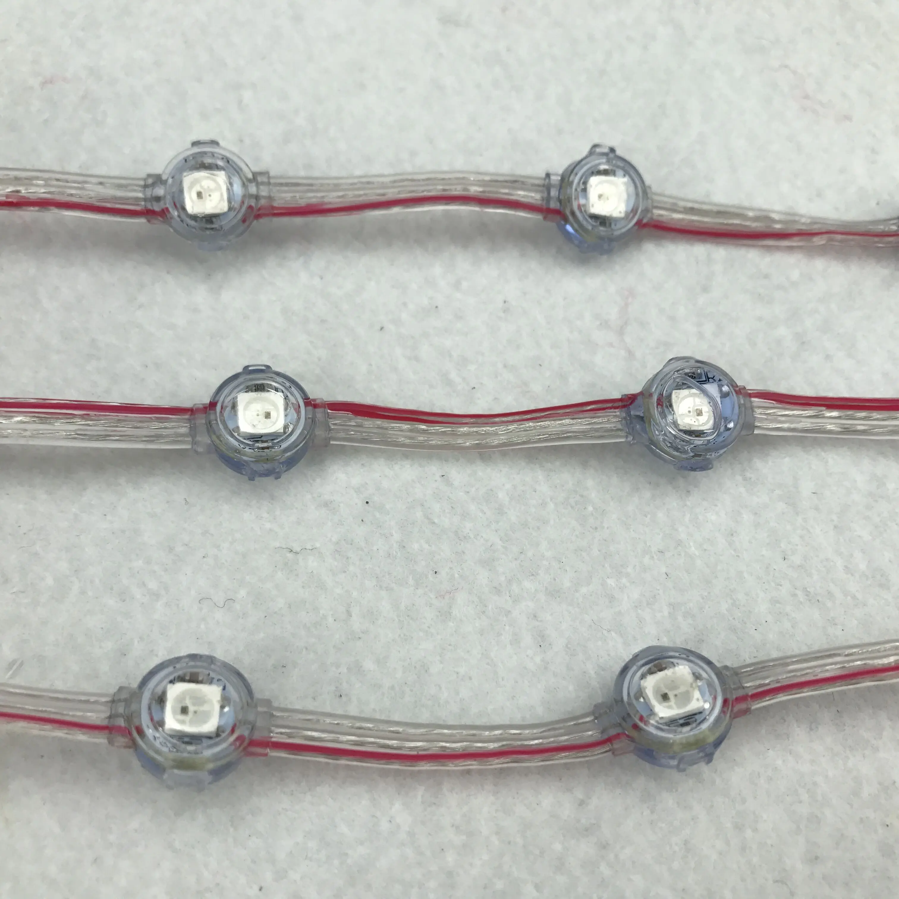 

Addressable SK6812 DC12V IP68 LED pixel string;5cm wire spacing;40pcs a string;RGB full color;clear wire