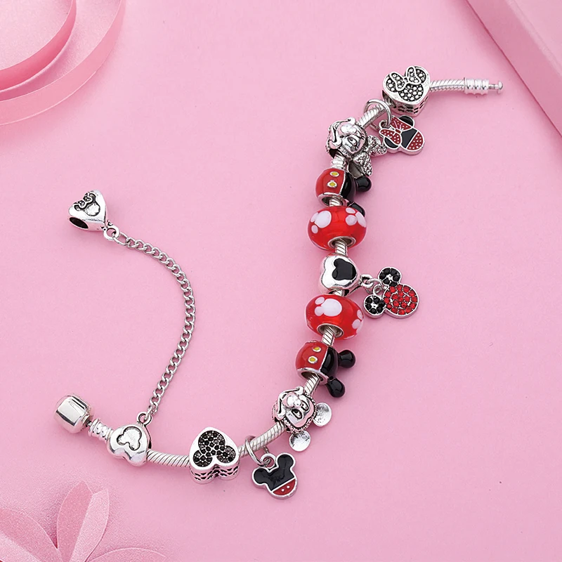 A new Red and silver Charm Bracelet Mickey Minnie with Disney Minnie Mouse charms.