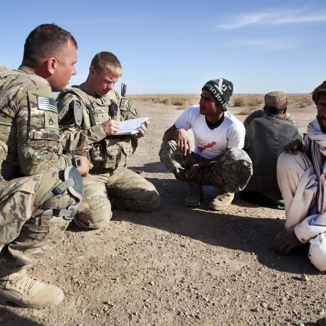 U.S. Army soldiers speak with elders in Afghanistan Poster Print (17 x 11)