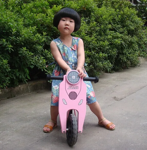 pink wooden balance bike