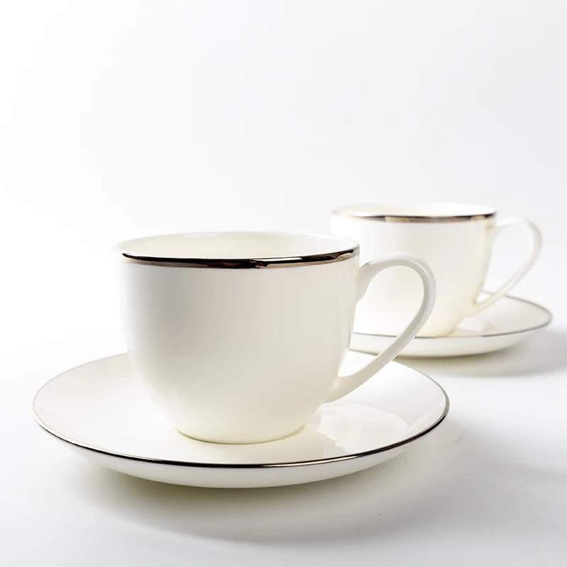 white and gold cup and saucer