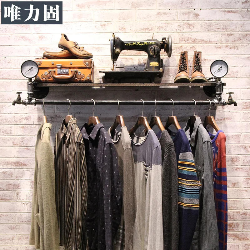 Vintage clothing store display racks on old wood pipes do men and women
