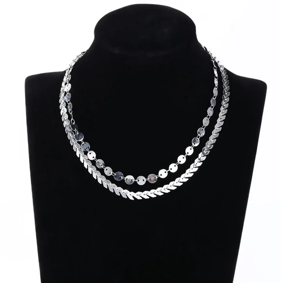 Model wearing layered choker necklace in elegant fashion style.