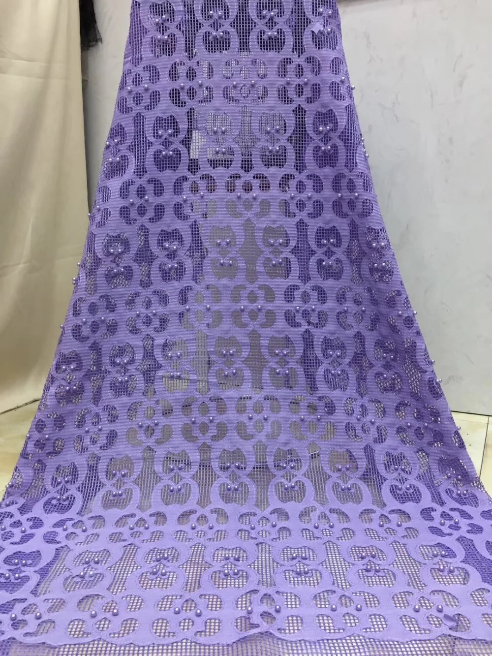 

Laser-cut lace, French embroidered lace and beaded party dresses are hot new items in Nigeria