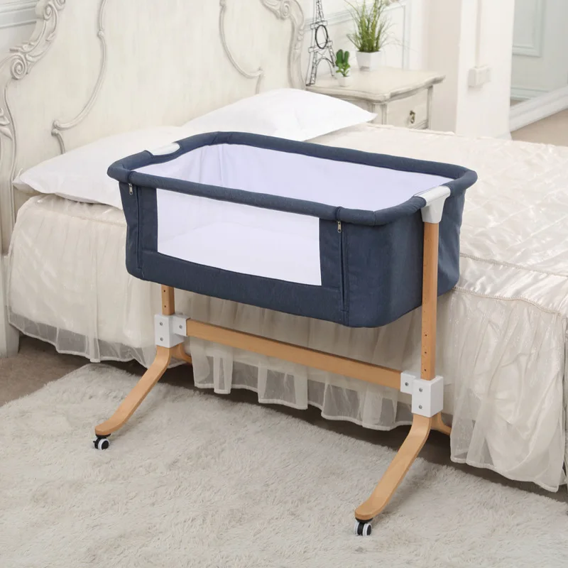 baby cot connected to bed