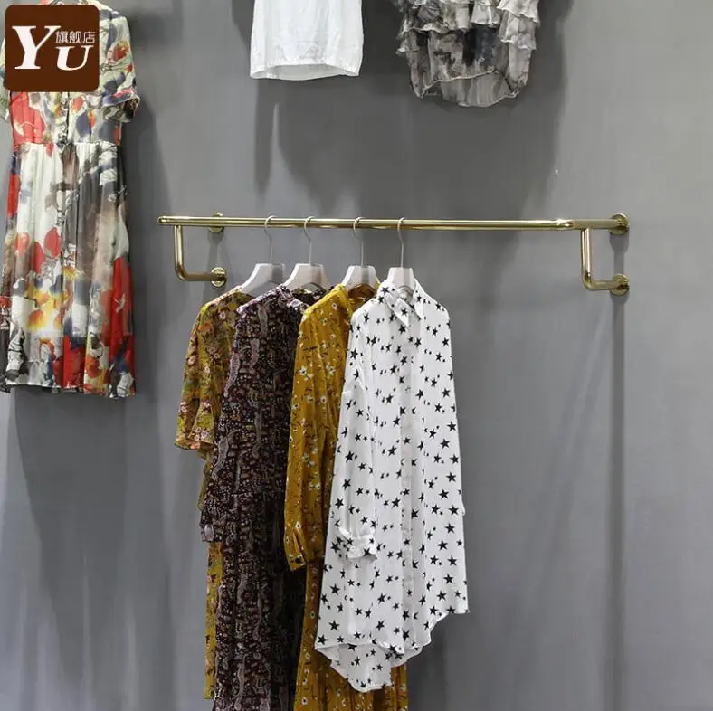 

Clothing store shelf display rack wall hanging side hanger yellow titanium gold wall round pipe hanger