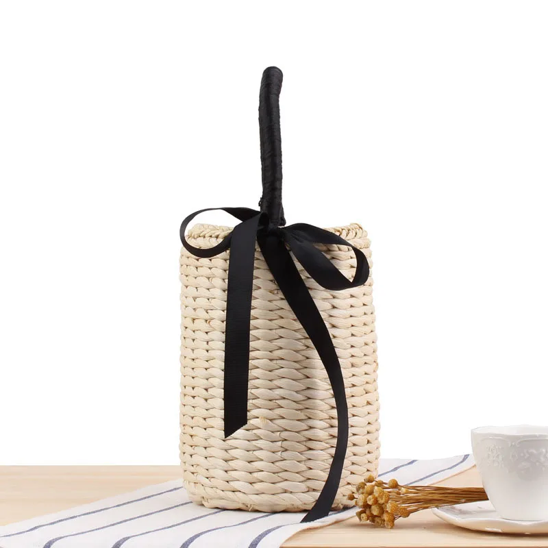 FEMALEE الصيف الأسود أشرطة القوس القش اليد النسائية الحلو الصور دلو الأعلى مقبض حقيبة أسطواني المنسوجة سلسلة عطلة حقائب