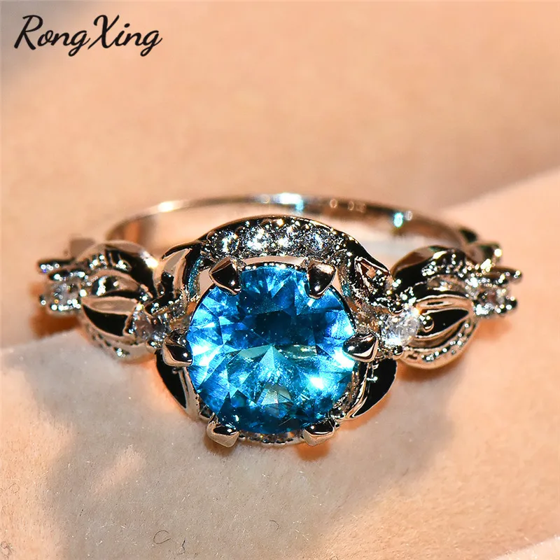 

RongXing Mystic Round Stone Lake Blue Birthstone Rings For Women White Gold Zircon Leaf Crossed Finger Ring CZ Wedding Jewelry