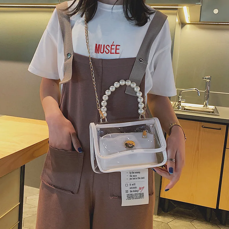 الفاخرة مصمم Crossbody أكياس شفافة PVC النساء حزمة تألق سلسلة حقيبة كتف الإناث أعلى-حقائب بيد مع اللؤلؤ الفاخرة مصمم Crossbody أكياس شفافة PVC النساء حزمة تألق سلسلة حقيبة كتف الإناث أعلى-حقائب بيد مع اللؤلؤ