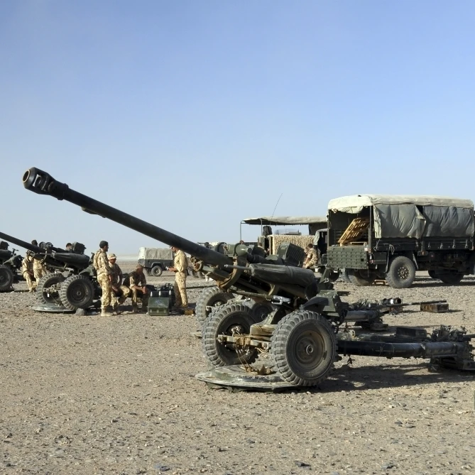Howitzer 105mm light guns are lined up at Camp Bastion  Afghanistan Poster Print (17 x 11)