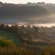 Misty morning valley with village  Uley  Gloucestershire  England Poster Print (36 x 13)