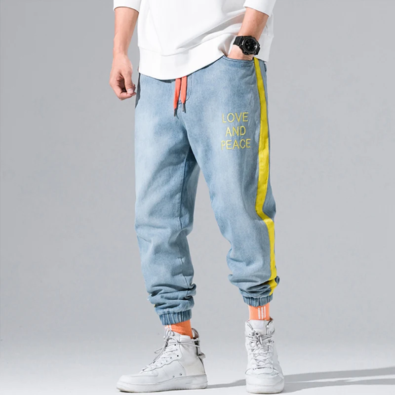Meilleur Automne hiver mode hommes Jeans jaune rayure épissé Cargo pantalon lettre imprimé Streetwear Hip Hop pantalon conique survêtement Jeans hommes