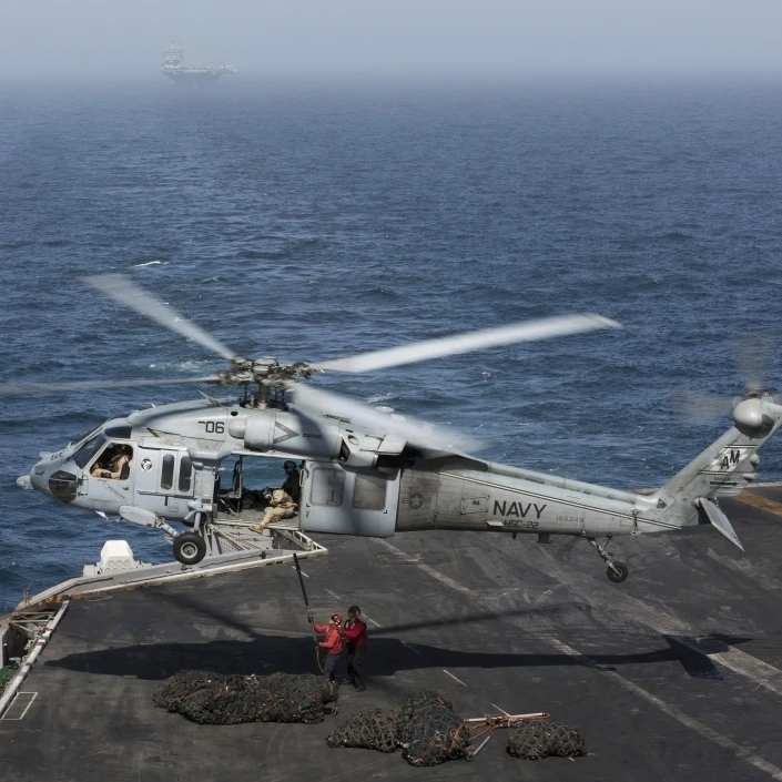 A MH-60S Knighthawk conducts a vertical replenishment at sea Poster Print (33 x 23)