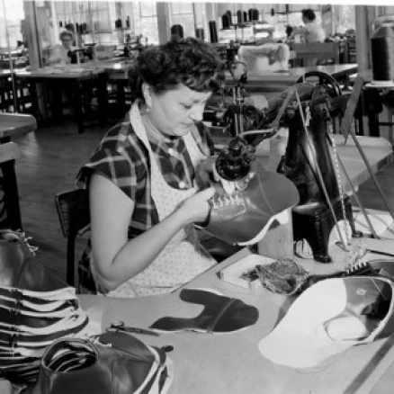 Woman in factory sewing shoe Poster Print (18 x 24)