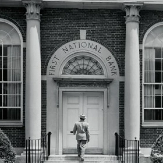 Rear view of a man entering a bank Poster Print (24 x 36)