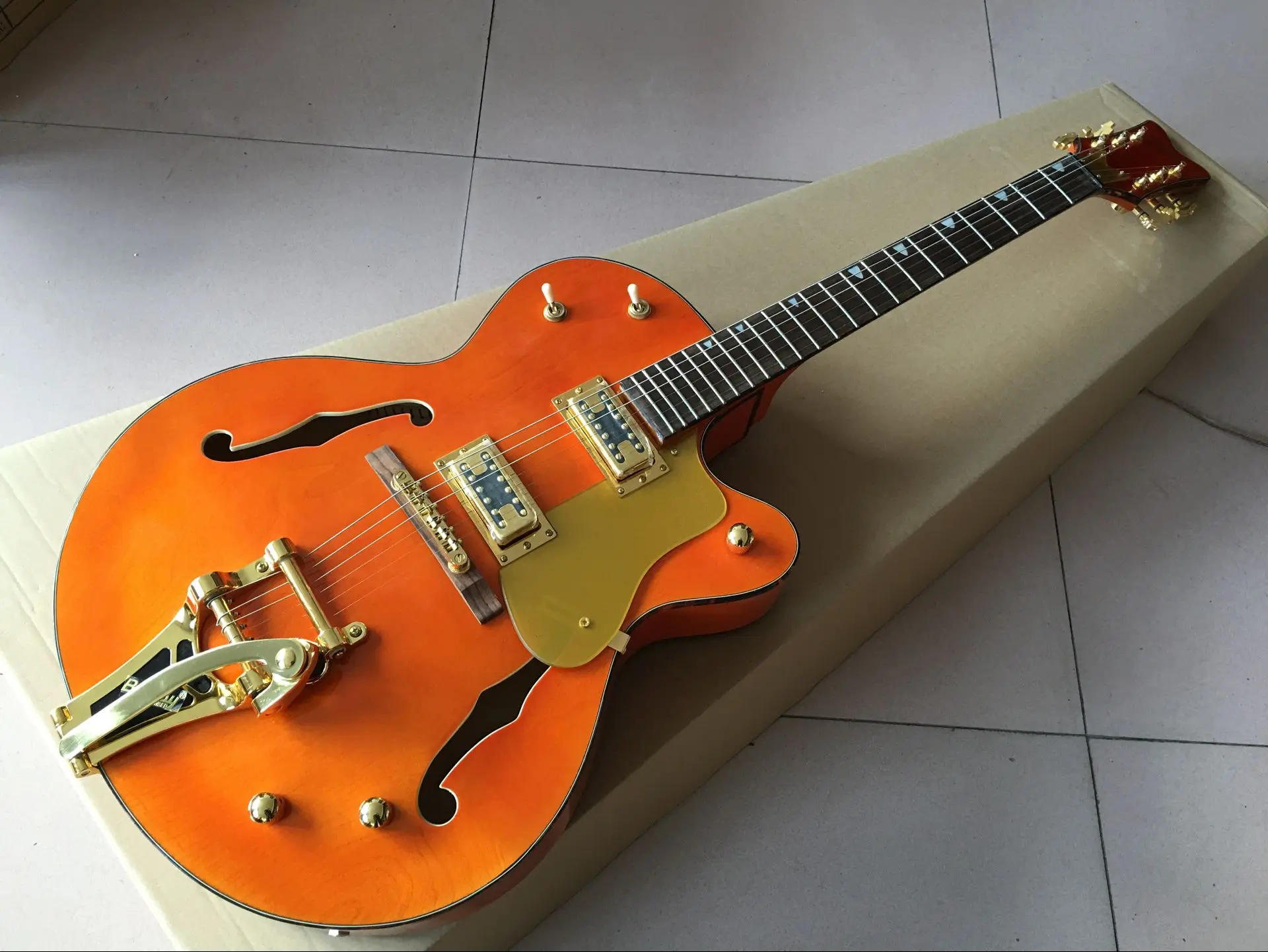 

China firehawk electric Orange color Hollow jazz guitar, big jazz tremolo system, gold hardware Free shipping