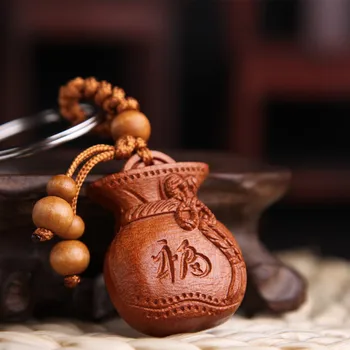 

1-(10pcs)Peachwood carving key ring wholesale money bag car key ring hanging piece of the key chain gift.