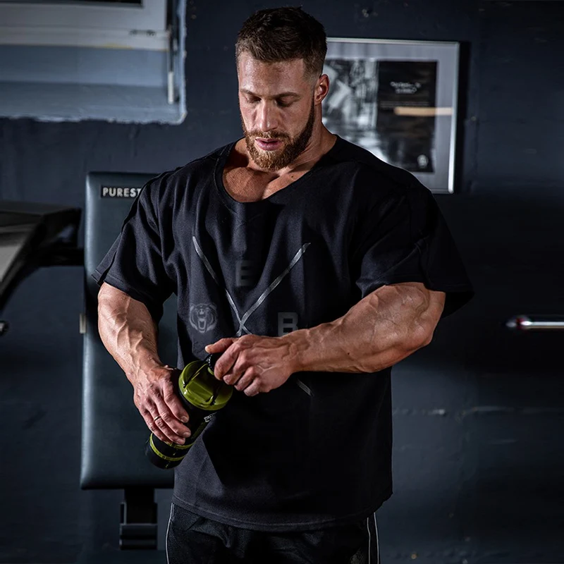 Bodybuilder in a Hood in the Gym