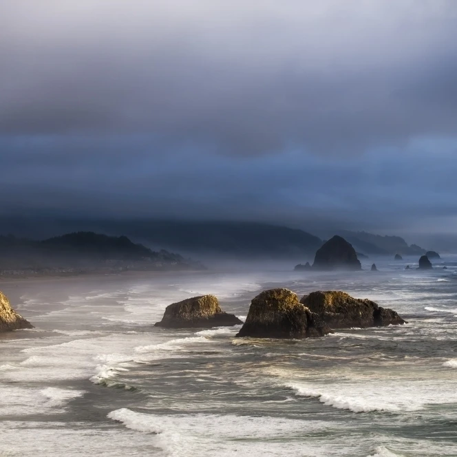 Sunlight and mist create coastal moods; Cannon Beach  Oregon  United States of America Poster Print (19 x 12)