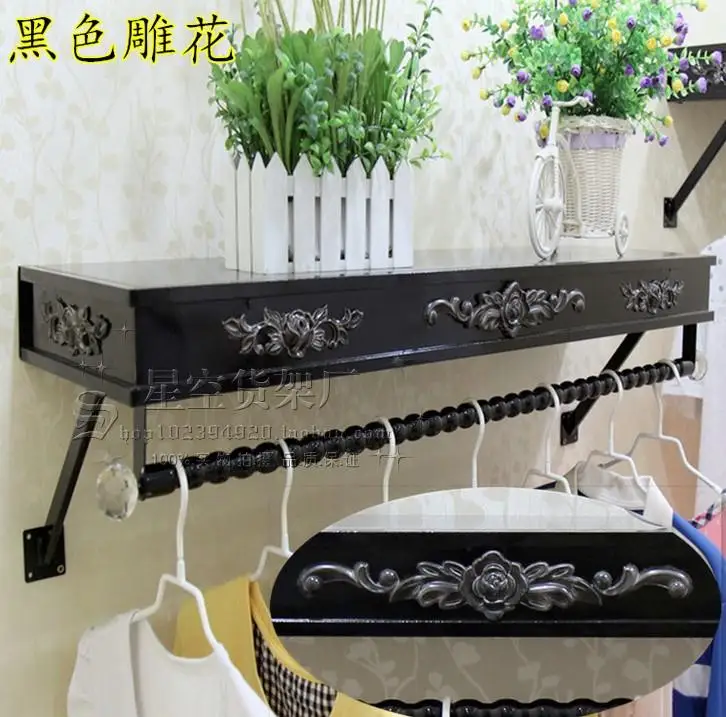 Clothes hangers show. On the wall clothing. Clothing store shelves of carve patterns or designs on woodwork hanging.