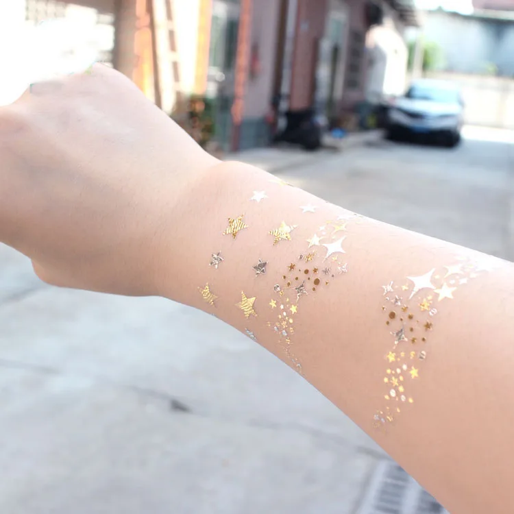 Gold moon and stars nail tattoos