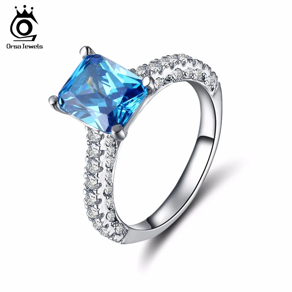 

ORSA JEWELS 2019 Fashion 3 Row Crystal Wedding Ring with Big Ocean Blue Zircon Cut Surrounded by AAA Austrian CZ for Women OR139