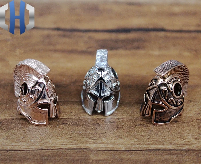 

Three-color 316L Stainless Steel Spartan Helmet Knife Beads Blade Buckle EDC Umbrella Rope Pendant EDC Multi Tools
