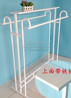 Clothing store display shelf. Console, wrought iron clothes frame. The parallel bars hangers.