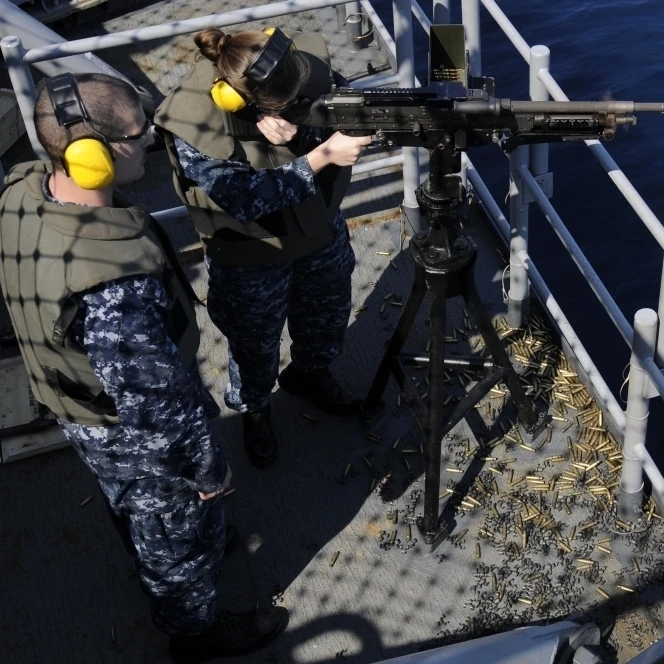 Sailor fires an M-240B machine gun aboard USS Wasp Poster Print (34 x 23)