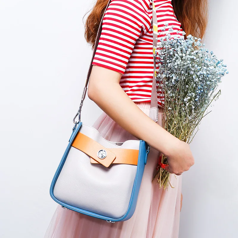 

Fashion luxurious brand magnetic buckle opening and closing shape Genuine Leather women handbags wide shoulder strap women bag