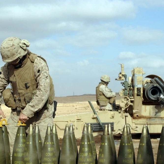 A U.S. Marine prepares howitzer rounds to be fired near Baghdad  Iraq Poster Print (17 x 11)