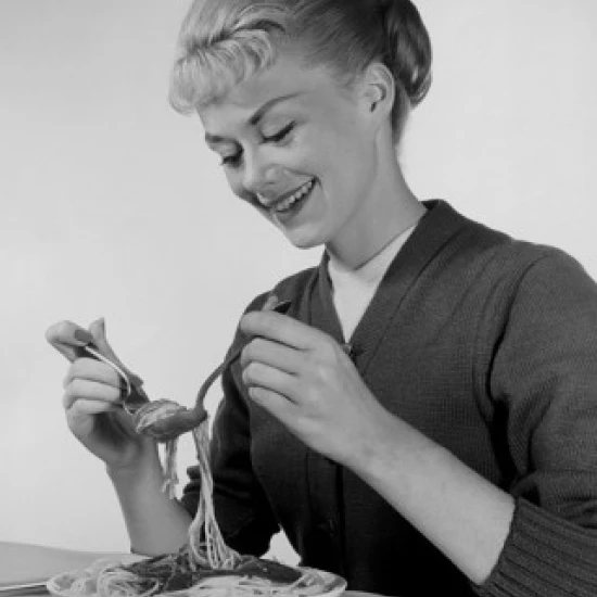 Young woman eating spaghetti Poster Print (24 x 36)