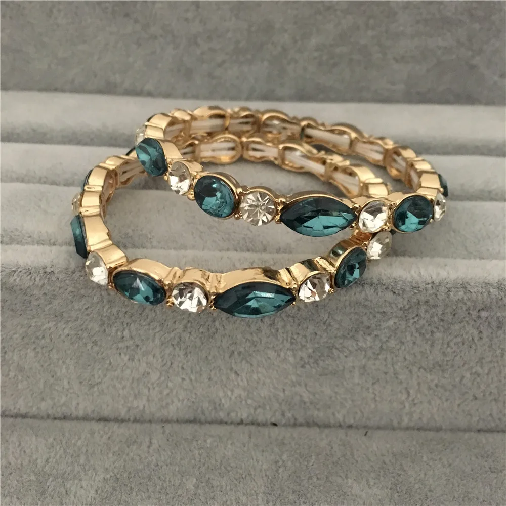 

CASUAL GOLD COLOR DAZZLING BLUE CLEAR STONE INSERTED ELASTIC STRAND BRACELET TWIN SET