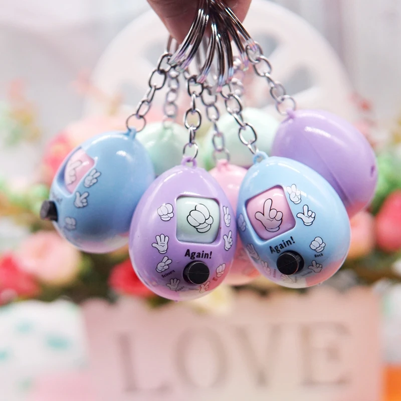 

Funny Family Games Button Press Stone Scissors Guessing Toy Plastic Round Egg Key Chain Tossed Eggs Guessing Toy For Kids