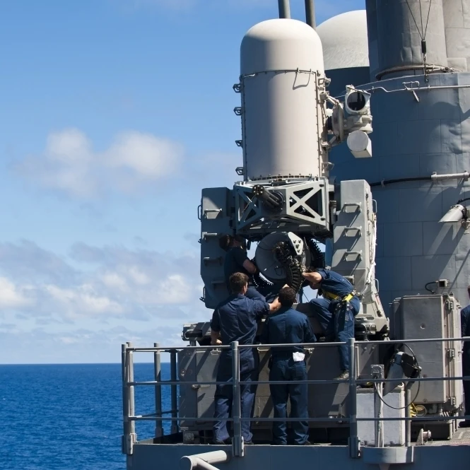 Sailors conduct maintenance on a Close-in Weapon System aboard USS Cowpens Poster Print (17 x 11)