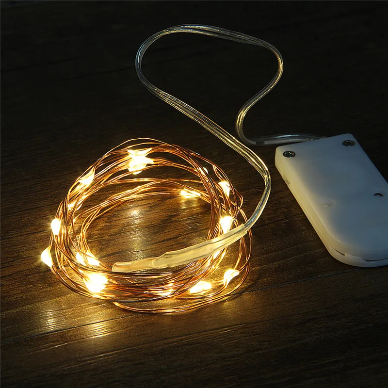 thumbnail image 1 of Luces LED de cobre de 1 m y 10 LED para Navidad, cadena de luces LED con botón CR2032 que funciona con pilas para decoración de bodas y Navidad, 1 of 4