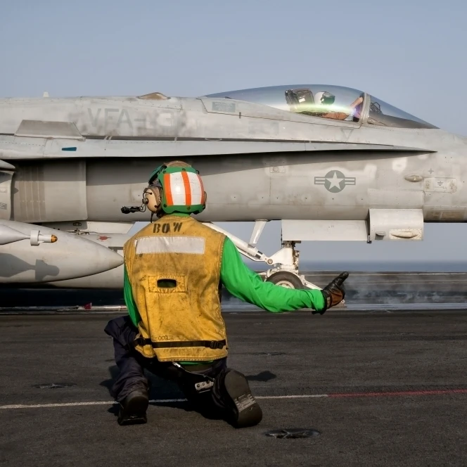 An F/A-18C is ready to launch from the flight deck of USS Eisenhower Poster Print (17 x 11)