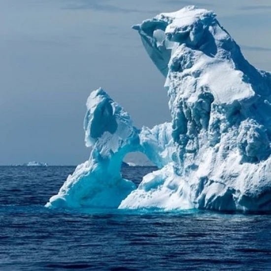An arched iceberg floating in Gerlache Strait  Antarctica. Poster Print by Paul Souders (23 x 35)
