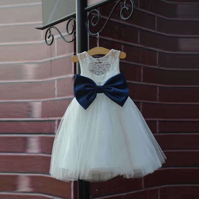 white flower girl dress with navy sash