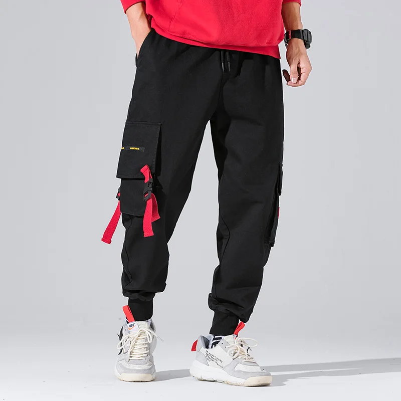 Baratos Nuevo Harajuku algodón Multi bolsillos estilo Safari pantalones cargo de moda hombres otoño Hip Hop Streetwear Casual pantalones elásticos Camo