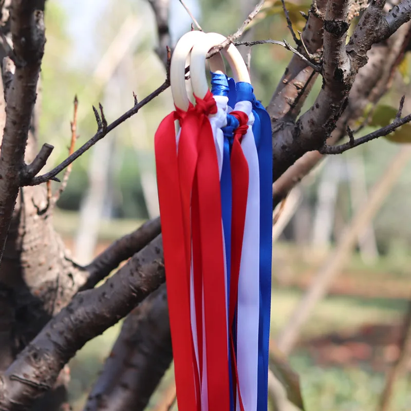 

Top Selling Blue + Red + white Stain ribbon Wooden Ring Waldorf With Bell Hand Kite Toy