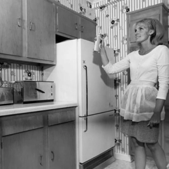Low angle view of a young woman spraying an aerosol can Poster Print (18 x 24)