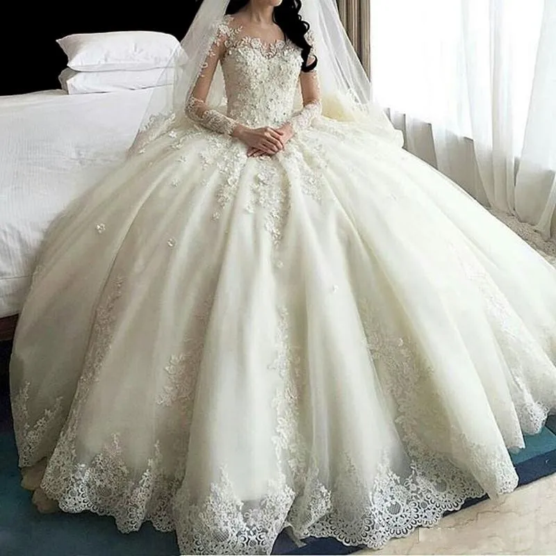 Luxury Ball Gown Wedding Dresses 2019 Sheer Neck Long Sleeves Covered Button Back Long Train Applique Beaded Modest Bridal Gowns